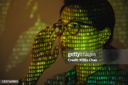 Portrait of business woman with binary matrix projected on her face Portrait of business woman with binary matrix projected on her face