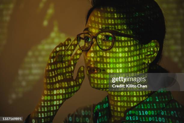 portrait of business woman with binary matrix projected on her face - face projection stock pictures, royalty-free photos & images