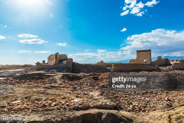 abandoned villages, dilapidated houses have had their roofs removed, leaving only walls. this used to be an area for oil exploitation. it was a house for workers. after oil exploitation, the workers moved away, and the village was abandoned. dunhuang city - gobi desert stock pictures, royalty-free photos & images