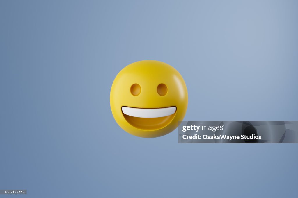 Computer graphics of yellow smiling round emoji isolated on pastel blue background
