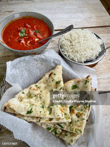 tasty chicken tikka masala with rice and garlic naan - naan stock pictures, royalty-free photos & images