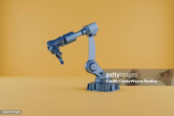 3d illustration of industrial robot isolated on orange color background - manufacturing equipment photos et images de collection