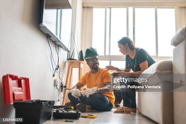 electrician working home client - electrical engineer stock pictures, royalty-free photos & images