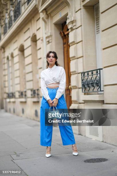 Ketevan Giorgadze @katie.one wears a white waist tie shirt from Le Ger, ocean blue high waist / cropped wide leg trousers / pants from The Frankie...