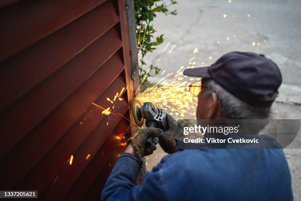 man are grinding an gate - gate stock pictures, royalty-free photos & images