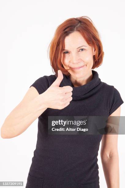a contented woman with thumbs up. - mature women thumbs stock pictures, royalty-free photos & images