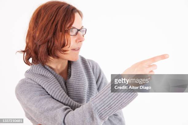 woman points her index finger in one direction. - portrait of pensive young businessman wearing glasses stock-fotos und bilder