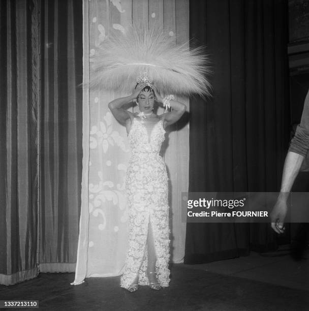 American-born, the artist Josephine Baker wears a headdress of 4,000 feathers for a rehearsal of her new revue 'Paris Mes Amours' at the Olympia...