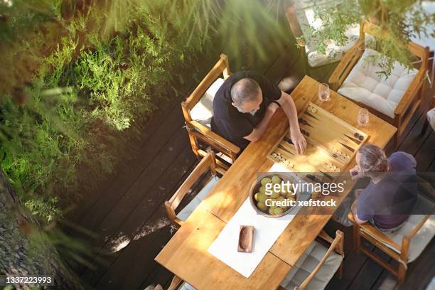 two men playing backgammon - backgammon stock pictures, royalty-free photos & images
