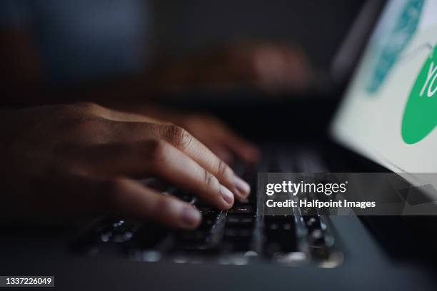 close-up of female hands working on laptop on bed indoors at home at night. - uomo donna per mano foto e immagini stock