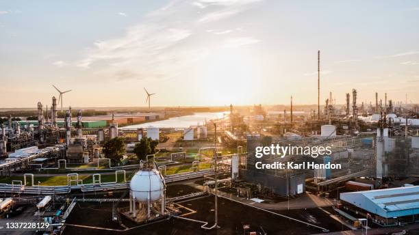 a surface level view of an industrial zone / power station at sunset - stock photo - energieindustrie stockfoto's en -beelden