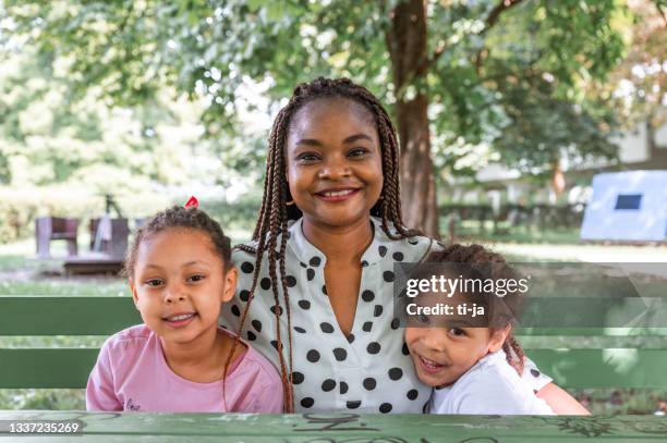 mother with two little children outdoors - family with two children stock pictures, royalty-free photos & images