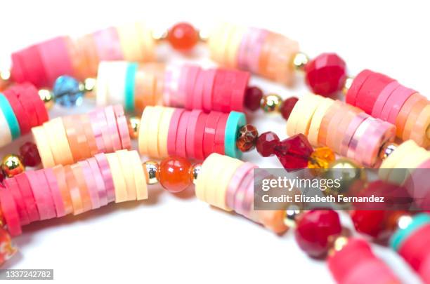 close-up of beaded jewelry on white background. copy space on image. - beaded bracelet stock pictures, royalty-free photos & images