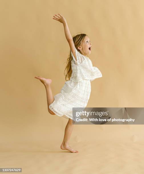 one little girl 6 years old dancing studio shot - 6 7 years stock-fotos und bilder