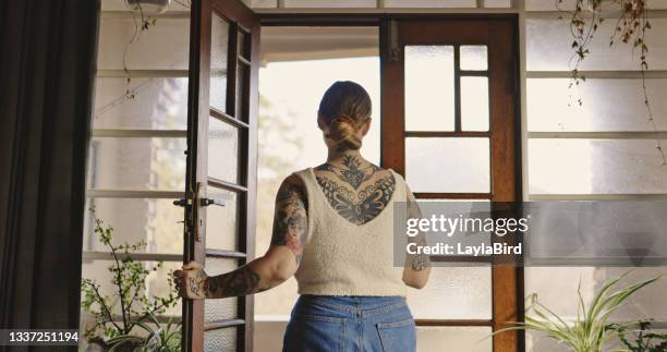 shot of a young woman relaxing at home - abrir a porta sair imagens e fotografias de stock