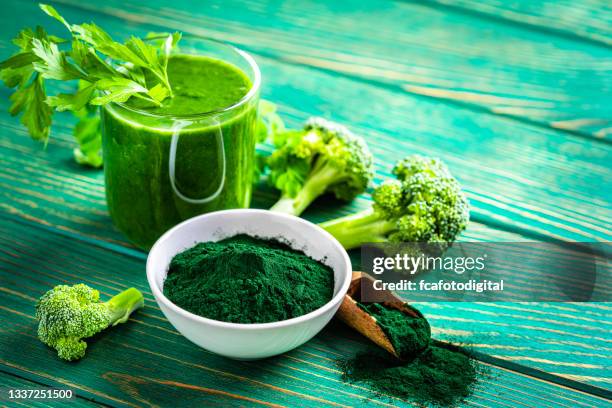 spirulina smoothie glass on green table. copy space - chlorella stock pictures, royalty-free photos & images