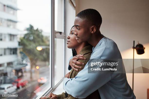 shot of a young couple enjoying time together at home - young adult couple stock pictures, royalty-free photos & images