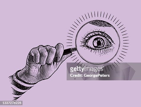 Hand holding magnifying glass with large eye