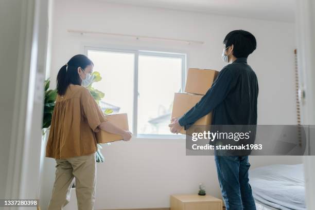 happy couple moving new house. - couple entering the theater stock pictures, royalty-free photos & images