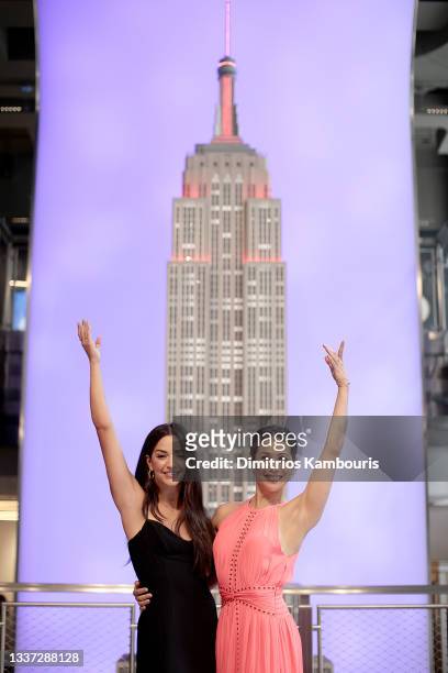 Ana Villafañe and Bianca Marroquín light The Empire State Building red in honor of the return of Broadway, on August 30, 2021 in New York City.