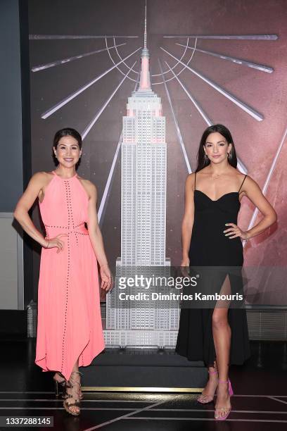 Bianca Marroquín and Ana Villafañe light The Empire State Building red in honor of the return of Broadway, on August 30, 2021 in New York City.
