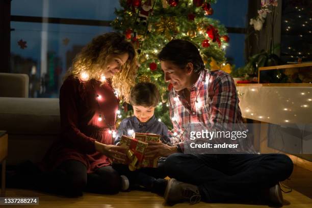happy family opening christmas presents - december 2020 stock pictures, royalty-free photos & images