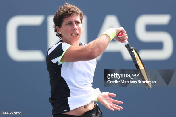 Carla Suárez Navarro of Spain returns Danielle Collins of the United States during their women's singles first round match on Day One of the 2021 US...