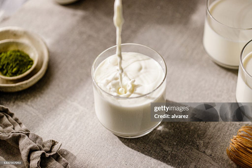 Pouring fresh milk in glass