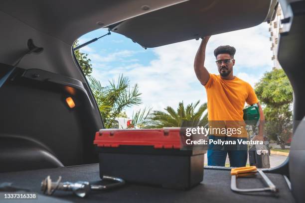 electrician plumber closing the trunk of the car - boot stock pictures, royalty-free photos & images
