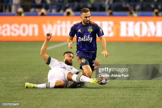 Bill Tuiloma of Portland Timbers and Nicolas Benezet of Seattle Sounders battle for possession in the second half at Lumen Field on August 29, 2021...