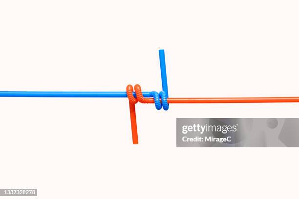 two interlocked drinking straws - abstract partnership stock pictures, royalty-free photos & images