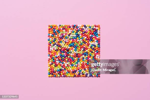 colorful sugar sprinkles crowded into a square shape - hagelslag stockfoto's en -beelden