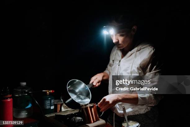 woman cooking food at night on the camping. - hot latin nights stock pictures, royalty-free photos & images