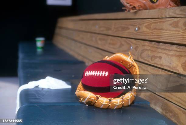 Detail of his baseball glove and a soft football used for warming up on the bench when 2nd Baseman Roberto Alomar of the Toronto Blue Jays appears in...