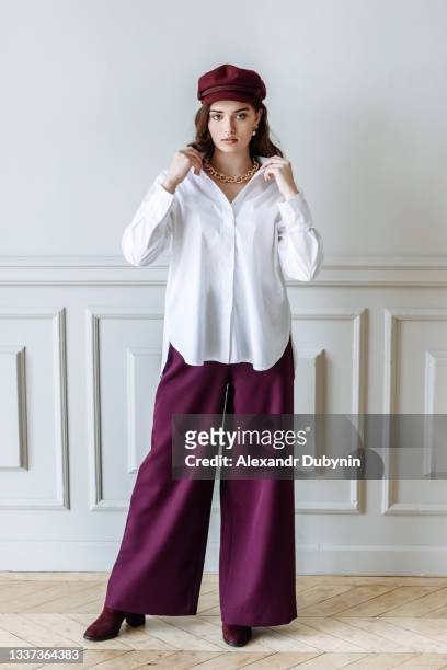 young woman model posing in studio in stylish clothes - purple shirt stock pictures, royalty-free photos & images