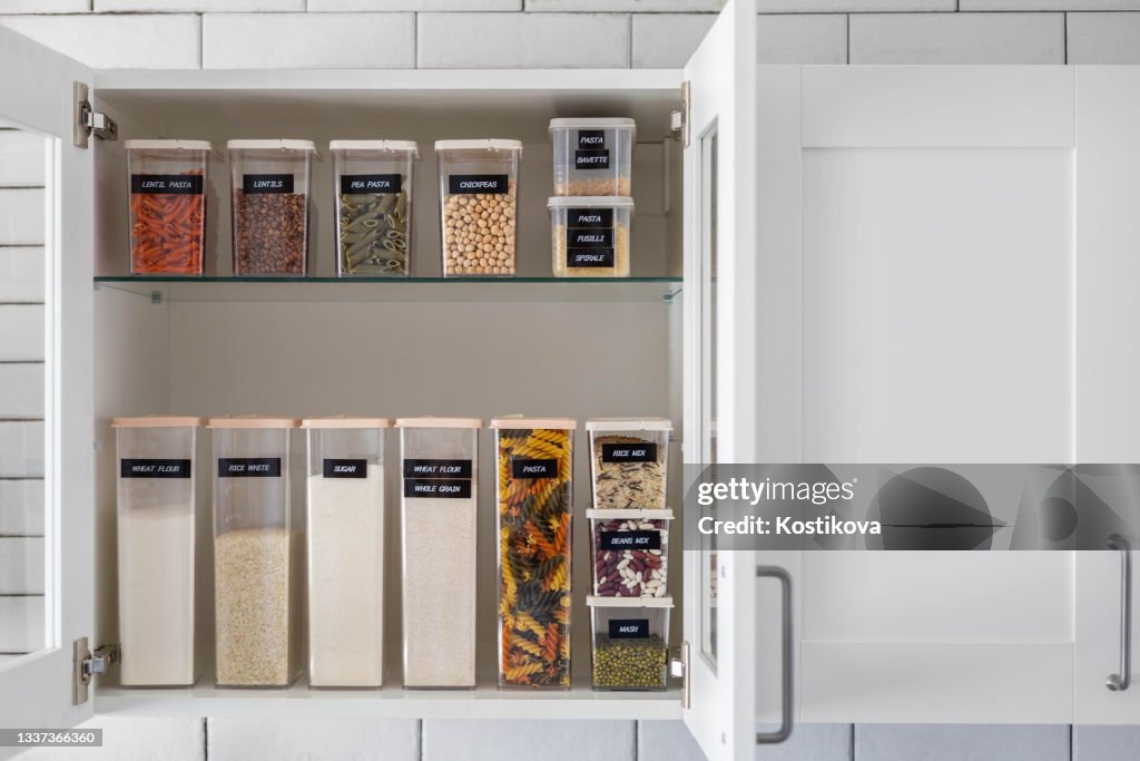 Kitchen storage organization use plastic case. Placing and sorting food products into pp box