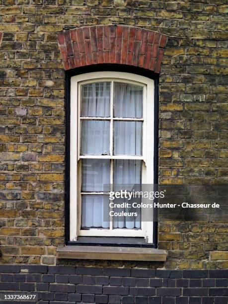georgian style white window and weathered brick wall in london - window frame exterior stock pictures, royalty-free photos & images