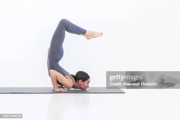 woman practicing stretching yoga on white background on mat. lifestyle sport concept - 622 32 ストックフォトと画像