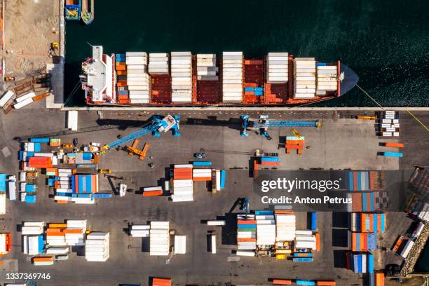 aerial view of commercial port, cargo ship and containers. worldwide transportation - shipyard aerial stock pictures, royalty-free photos & images