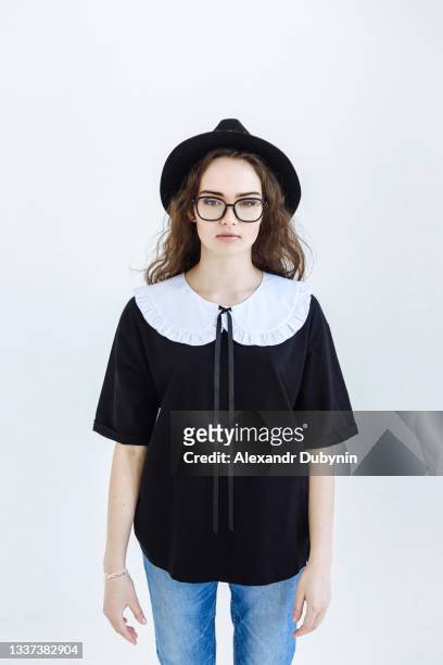 portrait of a young beautiful woman in a hat and glasses on a white background - collar stock pictures, royalty-free photos & images