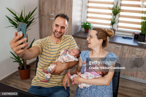 parents with baby taking selfie at home - photo shoot at home stock pictures, royalty-free photos & images