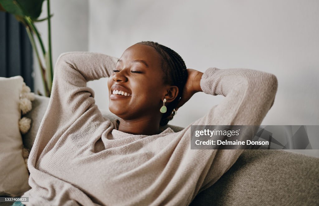Shot of a young woman relaxing on the sofa at home