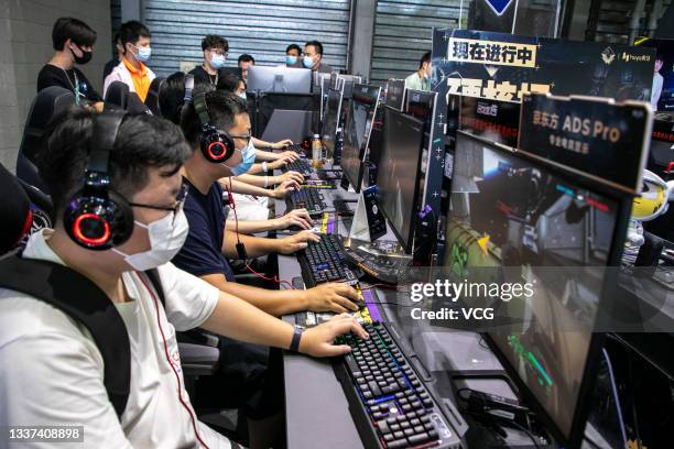 People play online games at the booth of Huya, a Chinese live-streaming platform for video games and e-sports, during the 19th China Digital...