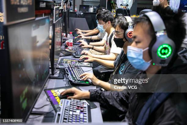 People play online games at the booth of Huya, a Chinese live-streaming platform for video games and e-sports, during the 19th China Digital...