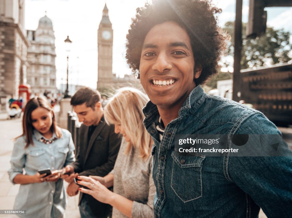 Smiling friends having fun in london