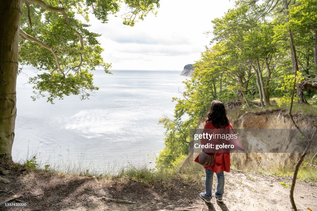 Woman looking from chalk rock coast on Rügen Island
