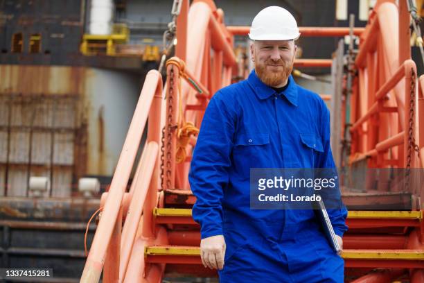 a male engineer at an oil and gas construction site - oil and gas workers imagens e fotografias de stock