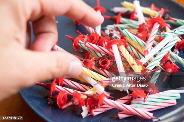 a person is going to pick up a candle from a pile of candles. - 50th birthday stock-fotos und bilder