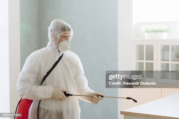 a professional contractor pests pests or viruses by disinfecting a home. coronavirus epidemic covid-19. - pest stock pictures, royalty-free photos & images