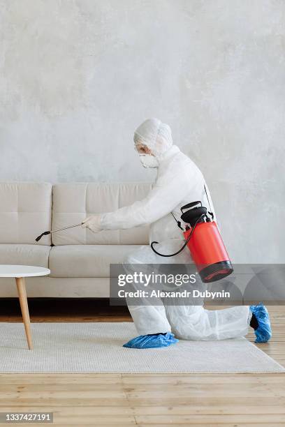 cleaning and disinfection at town complex amid the coronavirus epidemic. professional teams for disinfection efforts. infection prevention and control of epidemic. protective suit and mask - decontamination stock pictures, royalty-free photos & images